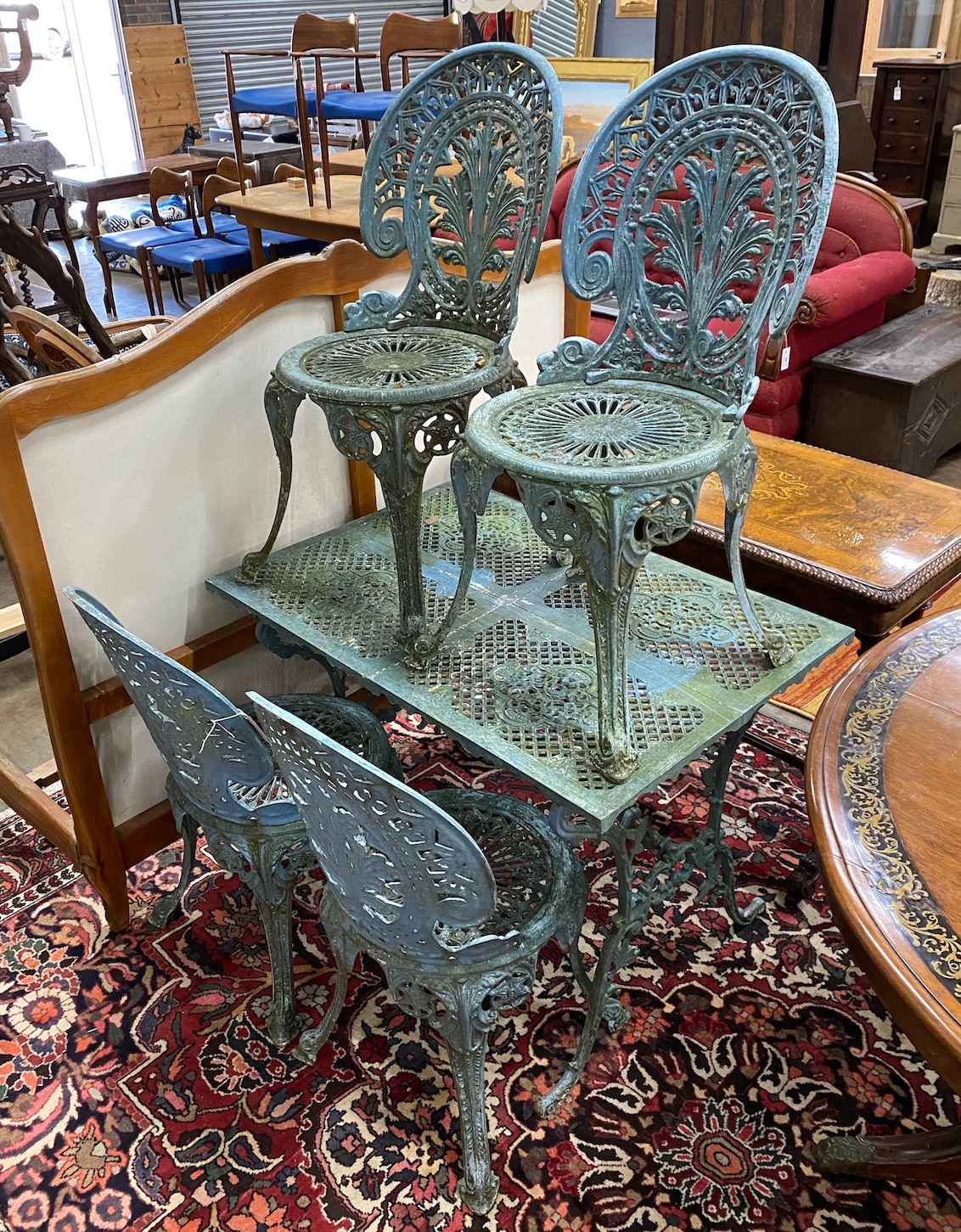 A Victorian style rectangular painted aluminium garden table, length 93cm, depth 63cm, height 69cm together with four aluminium garden chairs